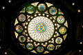Stained glass window with early US states seals surrounding that of Massachusetts in State House. Boston, MA.