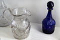 Mold-blown shell & ribbing design glass pitcher & bottles by Boston & Sandwich Glass Co. at Sandwich Glass Museum. Sandwich, MA.