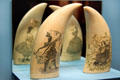 Scrimshaw native with bow & arrow plus female figures on whale teeth at Heritage Plantation. Sandwich, MA.