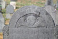 Tombstone with winged skull in Old Hill Burying Ground on Monument Sq. Concord, MA.