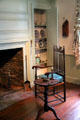 Chair beside parlor fireplace in Crowninshield-Bentley House of Peabody Essex Museum. Salem, MA.