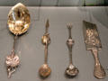 Silverware collection berry spoon by Wood & Hughes; olive spoons by Gorham Manuf.; & ice cream slicer by Frank W. Smith Silver Co. at Museum of Fine Arts. Boston, MA
