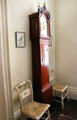 Tall case clock with two side chairs with caned seats at Nichols House Museum. Boston, MA.
