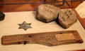 Tin star which once lead visitors to Thoreau's Walden Pond, wood fragment from Walden Pond house & stones from cairn which once marked Thoreau's front door at Concord Museum. Concord, MA.