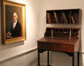 Bankers' writing desk beside portrait of Israel Thorndike in Bank room at John Cabot House. Beverly, MA.