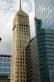 Heritage Foshay Tower sits between glass highrises. Minneapolis, MN.