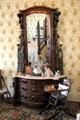 Dresser with mirror beside high chair at Chatillon-DeMenil Mansion. St. Louis, MO.