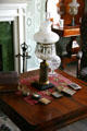 Becky Thatcher House parlor table & oil lamp at Mark Twain Boyhood Home & Museum. Hannibal, MO.