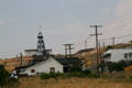Headframe stands above houses of Butte. Butte, MT.