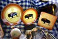 Bison decorate plates in shop window. West Yellowstone, MT