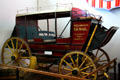 Wells Fargo open sided coach & US Mail wagon at Durham Western Heritage Museum. Omaha, NE.