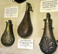 Three metal powder horns at Woodman Museum. Dover, NH.