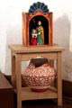 Spanish-style carving of nativity scene over native pot at San Miguel Mission. Santa Fe, NM.