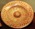 Spanish lusterware majolica plate with raised center at New Mexico History Museum. Santa Fe, NM.