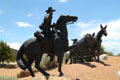Horse & rider meet mule drawn wagon in Journey's End Santa Fe Trail sculpture. Santa Fe, NM