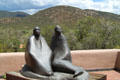 Dineh sculpture by Allan Houser against surrounding hills at Wheelwright Museum of the American Indian. Santa Fe, NM.