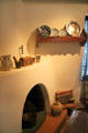 Collection of ceramics on fireplace of Delgado home display at Museum of Spanish Colonial Art. Santa Fe, NM.