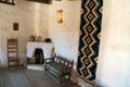 Corner fireplace & seats of reception room in La Placita at Rancho de las Golondrinas. Santa Fe, NM.