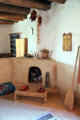 Room with corner fireplace in La Placita at Rancho de las Golondrinas. Santa Fe, NM.
