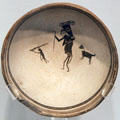 Mimbres classic black-on-white pottery bowl with woodgatherers at Maxwell Museum of Anthropology. Albuquerque, NM.