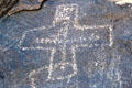 Petroglyph with cross at Petroglyph National Monument. Albuquerque, NM.