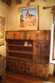 Our lady of Guadalupe church painting over carved cabinet by Nicolai Fechin at Taos Art Museum. Taos, NM.