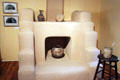 Stepped fireplace with pottery pieces at Blumenschein Home & Museum. Taos, NM.