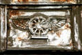 Winged rail wheel symbol rusted on Central Terminal building. Buffalo, NY.