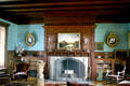 Fireplace in library in Clermont house with paintings & convex mirrors. Germantown, NY
