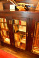 Bookcase with Roycroft name in dining room at Elbert Hubbard Roycroft Museum. East Aurora, NY.