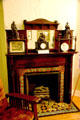 Fireplace with ceramic tile surround with shelves for statues at Susan B. Anthony House. Rochester, NY.