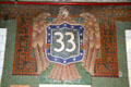 Eagle with #33 shield tiles in 33rd St. subway station done as a mosaic rather than solid tile. New York, NY.