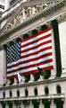 New York Stock Exchange frieze above American flag. New York, NY.