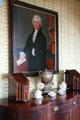 Portrait of Col. John Huntington Chester over dining room sideboard with silverware chests in Morris-Jumel Mansion. New York, NY.