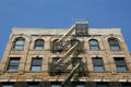 Heritage building with overhanging fire escape on Orchard St. New York, NY.