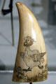 Scrimshawed whale's tooth of chicken with sailor's head at South Street Seaport Museum. New York, NY.