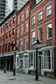 Heritage commercial buildings on Front St. in South Street Seaport district. New York, NY.