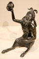 Shell lamp held aloft by seated Satyr with pan pipes bronze statuette by workshop of RICCIO of Padua, Italy at Metropolitan Museum of Art. New York, NY.