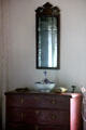 Mirror, bottle & basin on dresser in Schenck House bedroom at Old Bethpage Village. Old Bethpage, NY.
