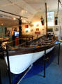 Whaleboat by New Bedford whaling brig Daisy at Whaling Museum. Cold Spring Harbor, NY.