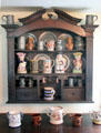 Wall cupboard with pewter, lusterware & Toby jug display at Home Sweet Home Museum. East Hampton, NY.