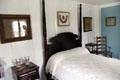 Four poster bed with double pair of double candlesticks on night table at Home Sweet Home Museum. East Hampton, NY.