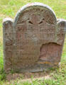 Old tombstone with winged face in South End Burying Grounds. East Hampton, NY.