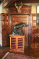 Entry hall statue of rhino on coin cabinet by Daniel Pabst & Frank Furness at Roosevelt's House Sagamore Hill NHS. Cove Neck, NY.