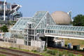 Glass structure of Lakeshore commuter rail North Coast station with stadium & Science Center beyond. Cleveland, OH.