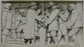 Relief of early settlers casting a canon on Bank of America Building. Providence, RI.