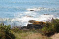 Waves break on rocks seen from The Breakers. Newport, RI.