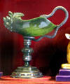 Jade sculpture of mythical creature with snake handle on stand with precious stones at The Elms. Newport, RI.