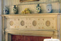 Fireplace with surround decorated with circles in relief at Kingscote. Newport, RI.