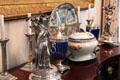 Silver candlesticks, centerpieces, urns & soup tureen on sideboard in dining room at Chepstow. Newport, RI.